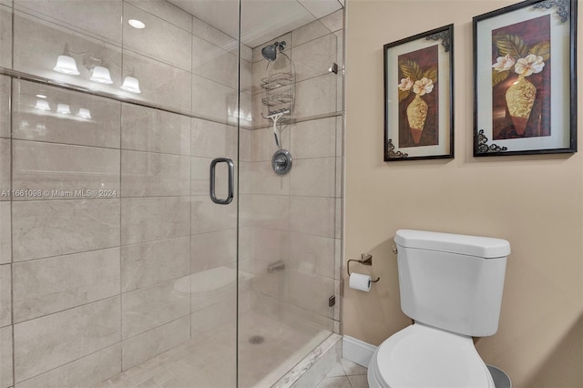 bathroom featuring walk in shower, toilet, and tile patterned floors