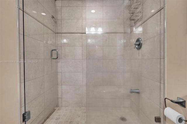 bathroom featuring a shower with door