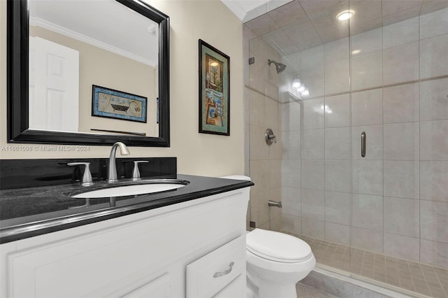 bathroom with crown molding, a shower with door, vanity, and toilet