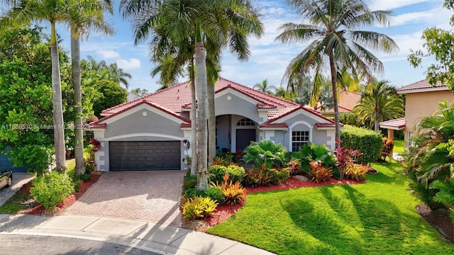 mediterranean / spanish-style house with a front yard and a garage