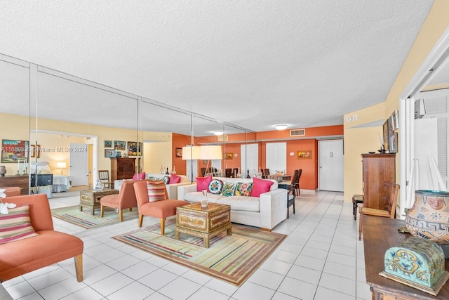 living room featuring a textured ceiling and light tile patterned flooring