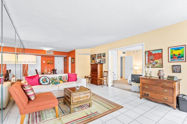 tiled living room featuring a textured ceiling