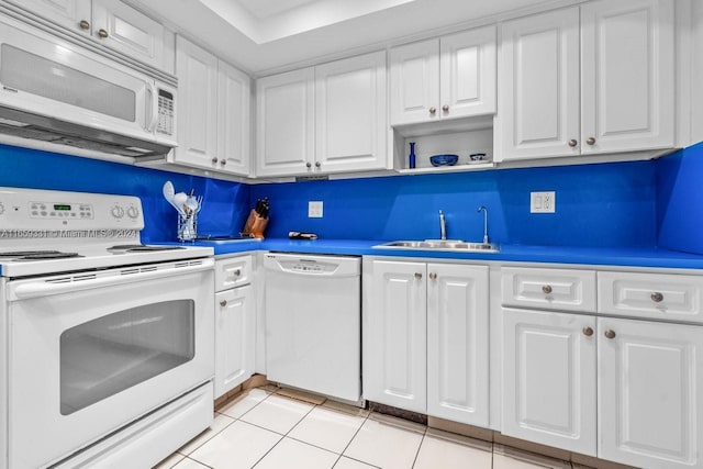 kitchen with tasteful backsplash, light tile patterned flooring, sink, white cabinets, and white appliances