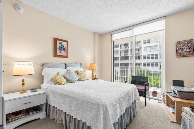 bedroom with carpet and a textured ceiling