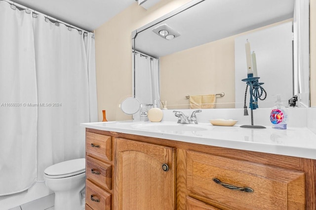 bathroom featuring tile patterned flooring, curtained shower, vanity, and toilet