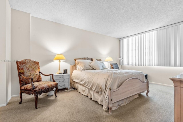 carpeted bedroom featuring a textured ceiling