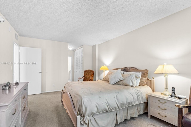 bedroom featuring a textured ceiling and light colored carpet