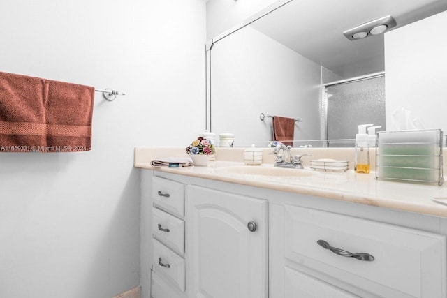 bathroom featuring walk in shower and vanity