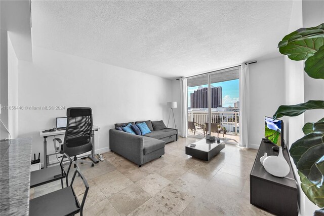 living room featuring floor to ceiling windows and a textured ceiling