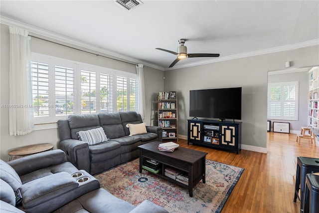 living room featuring wood-type flooring, ceiling fan, and crown molding