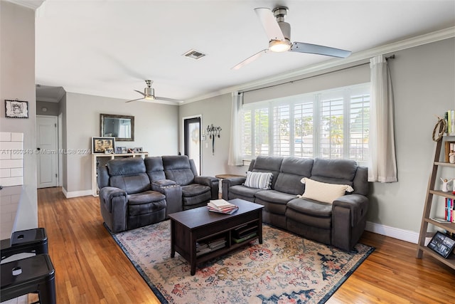 living room with wood-type flooring, ceiling fan, and crown molding