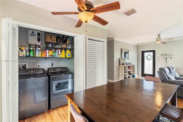 laundry area with ornamental molding, light wood-type flooring, ceiling fan, and separate washer and dryer