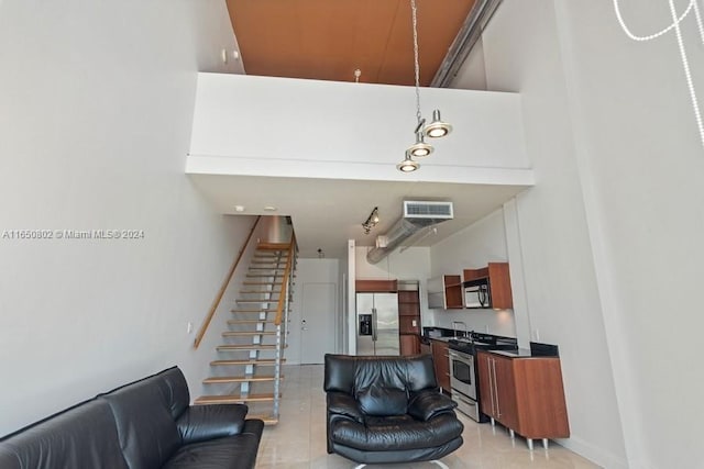 tiled living room with a towering ceiling