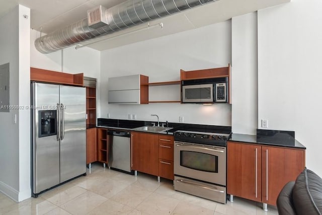 kitchen featuring light tile patterned floors, stainless steel appliances, and sink