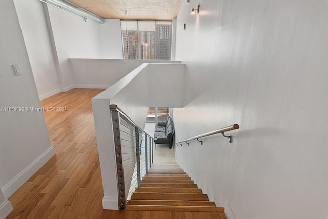 stairway with hardwood / wood-style flooring