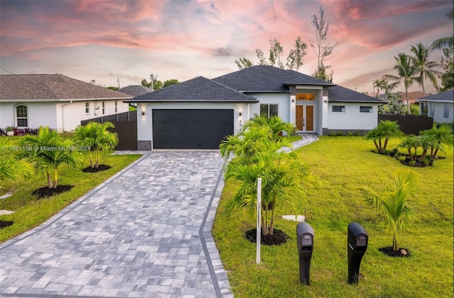 view of front of house featuring a lawn and a garage