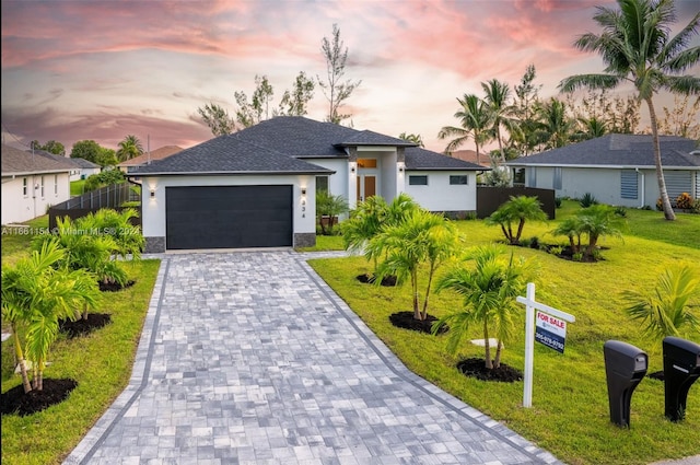 view of front of house featuring a lawn and a garage