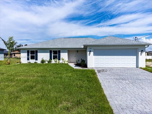 single story home featuring a garage and a front lawn