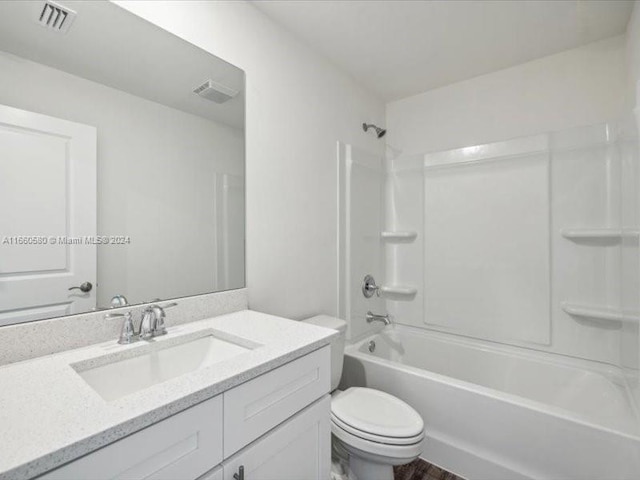 full bathroom featuring shower / tub combination, vanity, and toilet