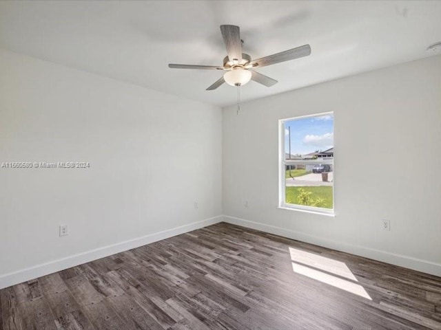 spare room featuring ceiling fan and dark hardwood / wood-style floors