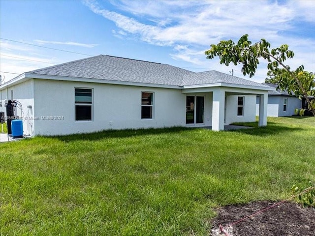 back of house with a yard