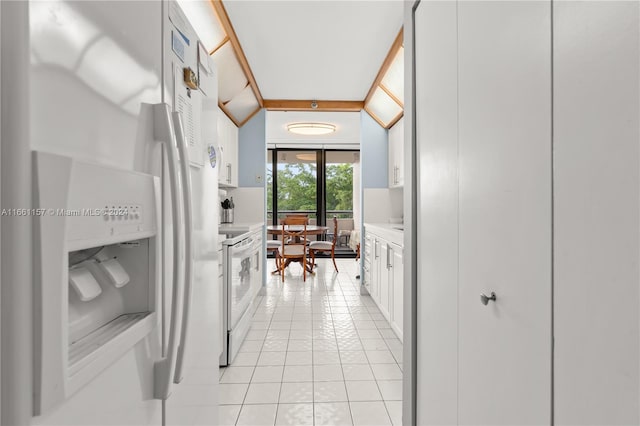 kitchen with white cabinetry, white appliances, and light tile patterned flooring