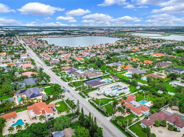 birds eye view of property with a water view