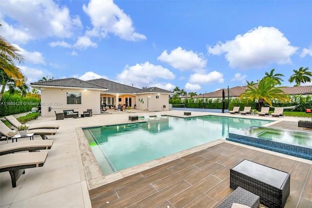 view of swimming pool featuring an in ground hot tub and a patio