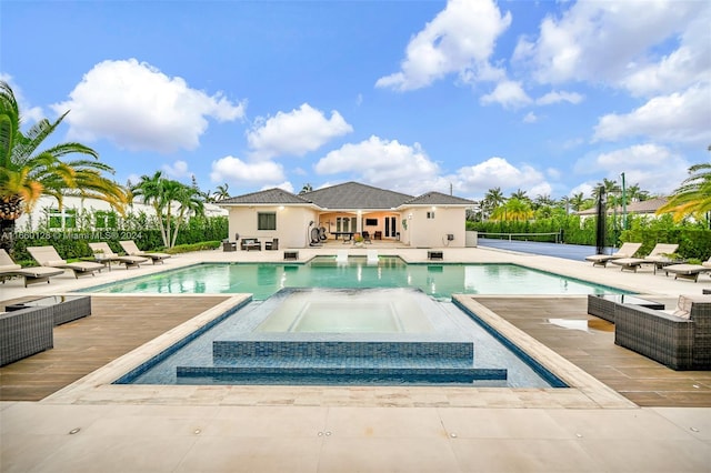 view of swimming pool with an in ground hot tub and a patio area