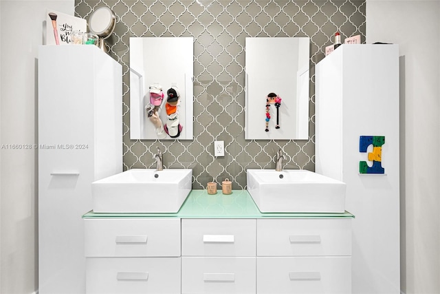 bathroom featuring vanity and decorative backsplash