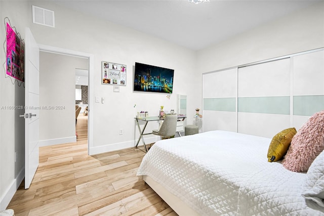 bedroom featuring hardwood / wood-style floors and a closet