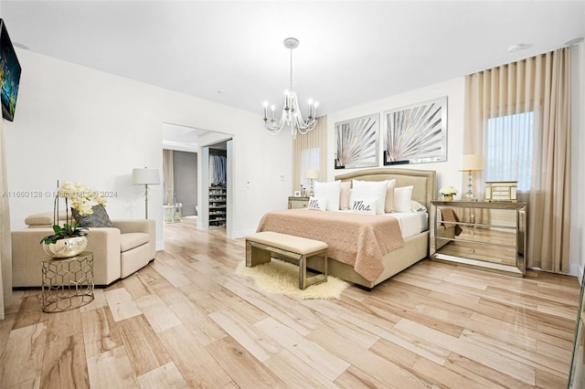 bedroom with light hardwood / wood-style flooring and an inviting chandelier