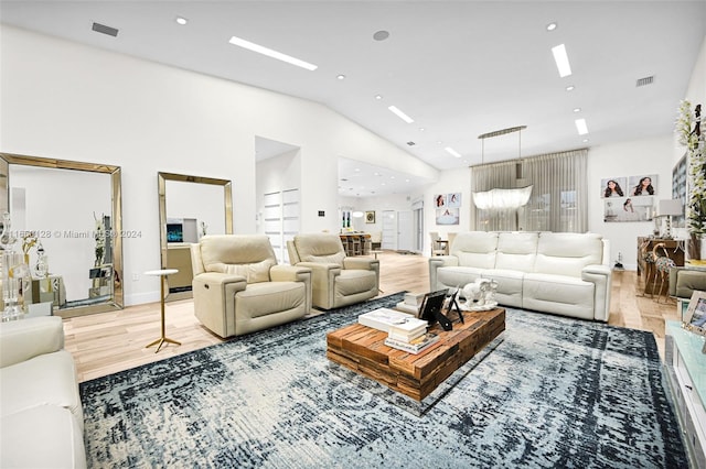 living room with vaulted ceiling and hardwood / wood-style flooring