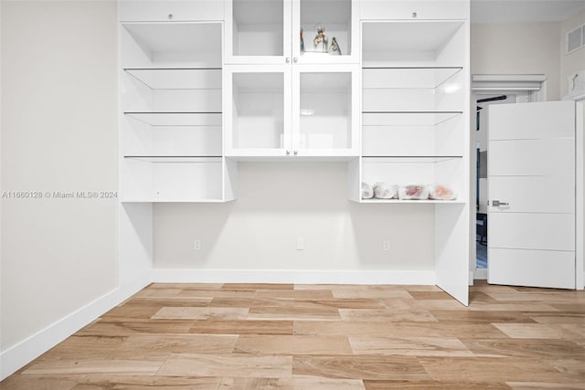 spacious closet with light hardwood / wood-style floors