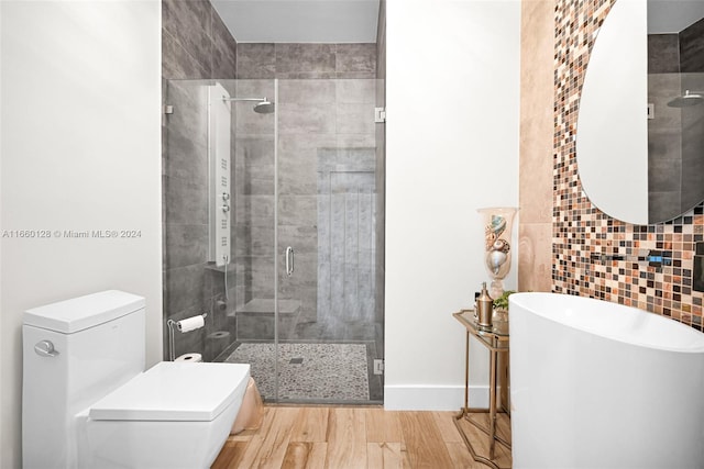 bathroom featuring walk in shower, hardwood / wood-style flooring, and toilet