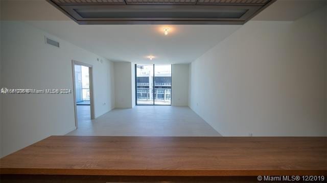 unfurnished room featuring floor to ceiling windows