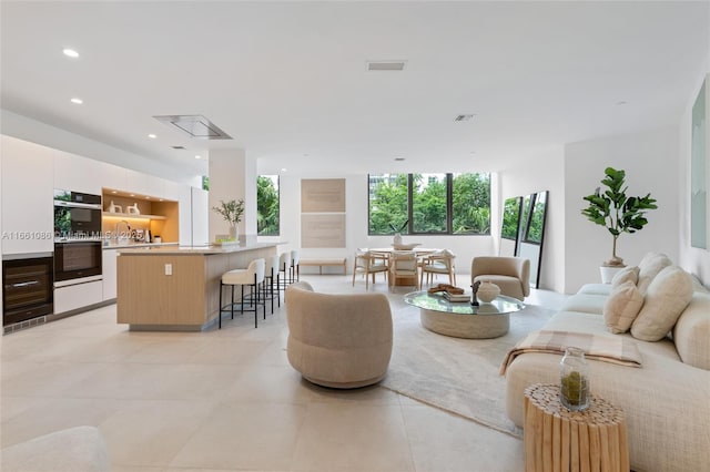 living room featuring sink and floor to ceiling windows