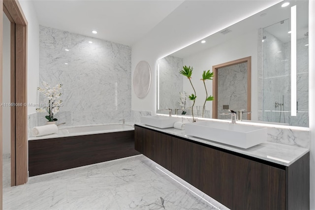 bathroom featuring vanity, tile walls, and a bathtub