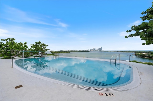 view of swimming pool with a water view