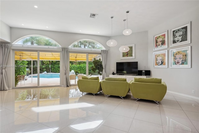 living room featuring plenty of natural light and light tile patterned floors