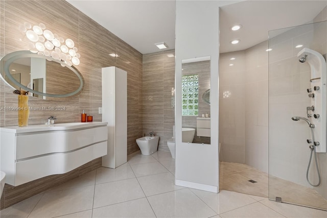 bathroom featuring a tile shower, tile walls, tile patterned flooring, a bidet, and vanity