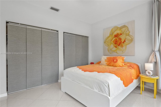 tiled bedroom with two closets