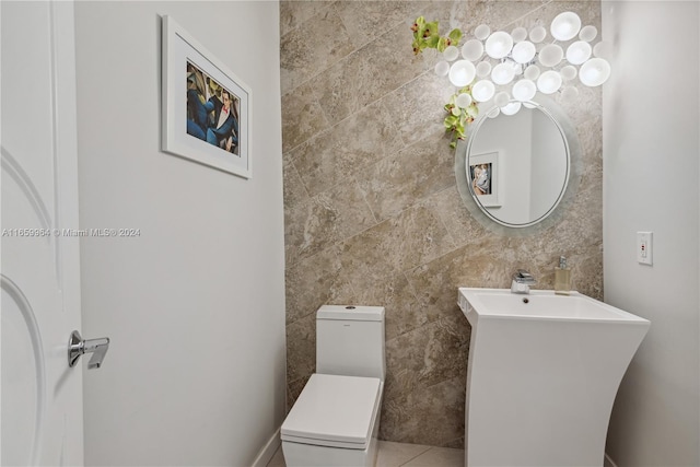 bathroom with tile walls and toilet