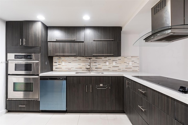 kitchen featuring decorative backsplash, appliances with stainless steel finishes, dark brown cabinetry, and extractor fan