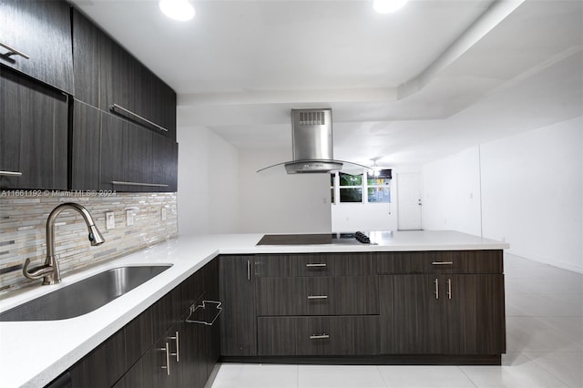 kitchen featuring light tile patterned floors, sink, tasteful backsplash, island range hood, and black stovetop