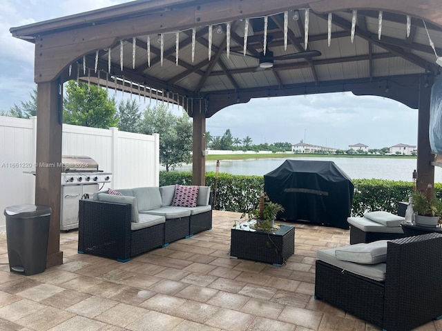 view of patio / terrace featuring an outdoor hangout area, a water view, grilling area, and a gazebo