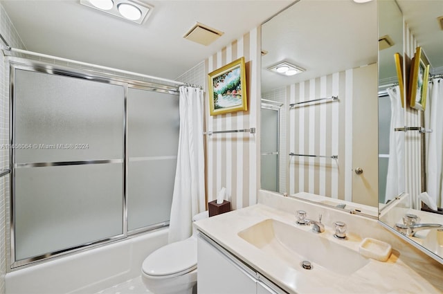 full bathroom featuring shower / tub combo, vanity, and toilet