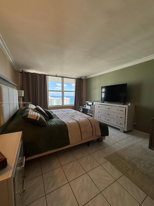 bedroom with ornamental molding and light tile patterned flooring