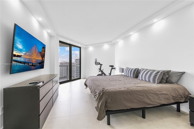 bedroom with a wall of windows and access to outside