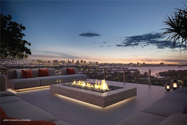 patio terrace at dusk featuring an outdoor living space with a fire pit and a water view